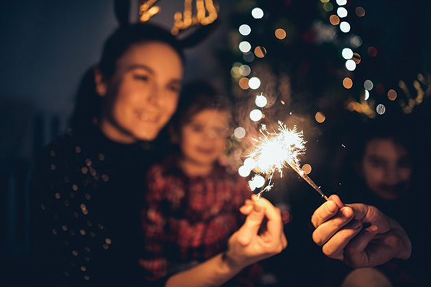 A family celebrates New Year's Eve at home.