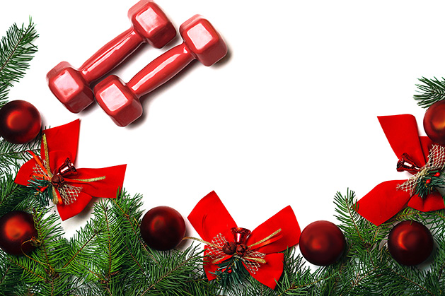 A pair of weights rest on a white background with holiday decor.
