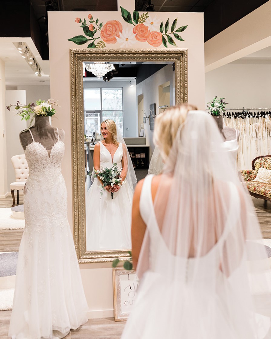 Woman tries on a wedding dress at Our Shop Bridal.