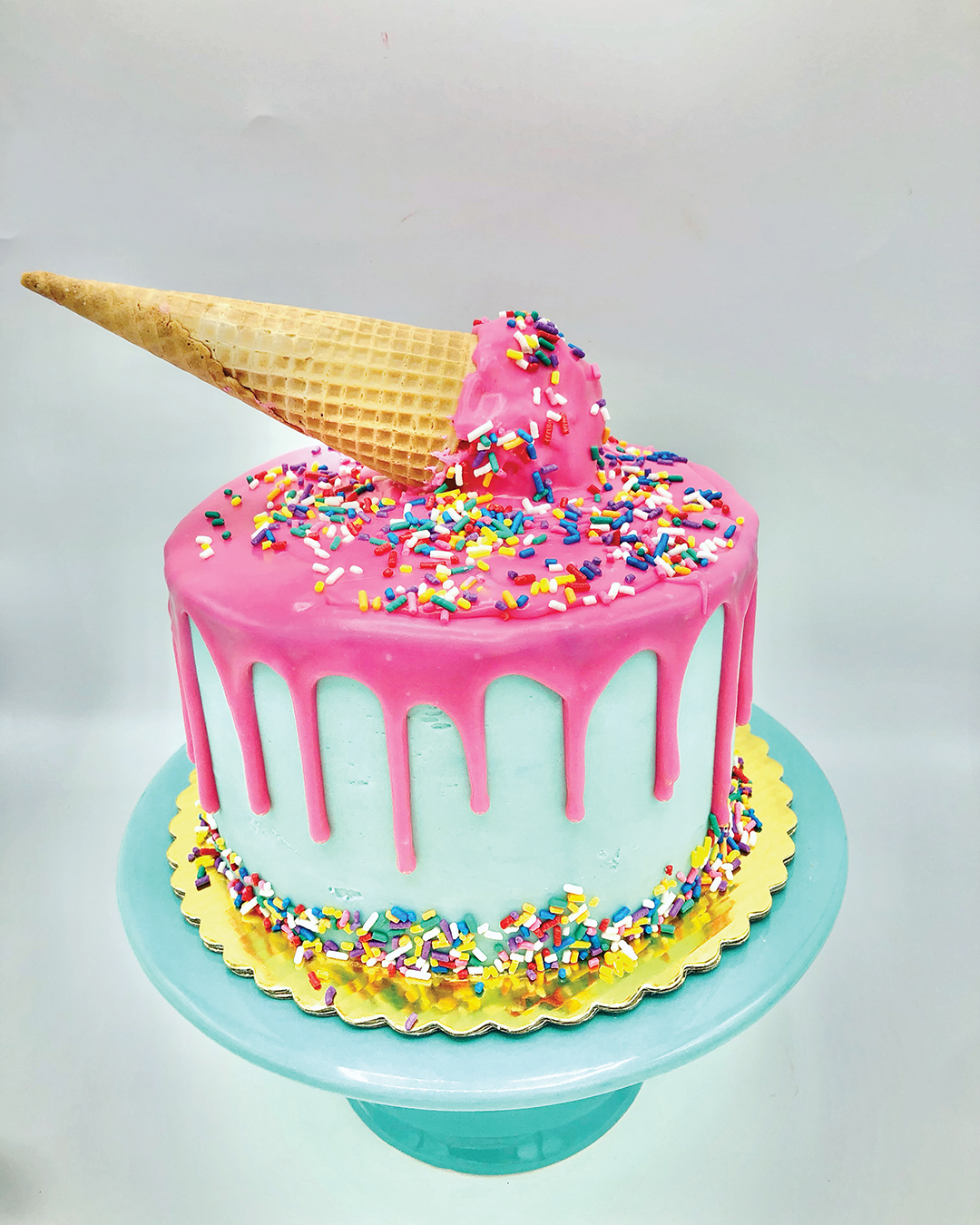 Cake decorated with an ice cream cone made out of frosting.