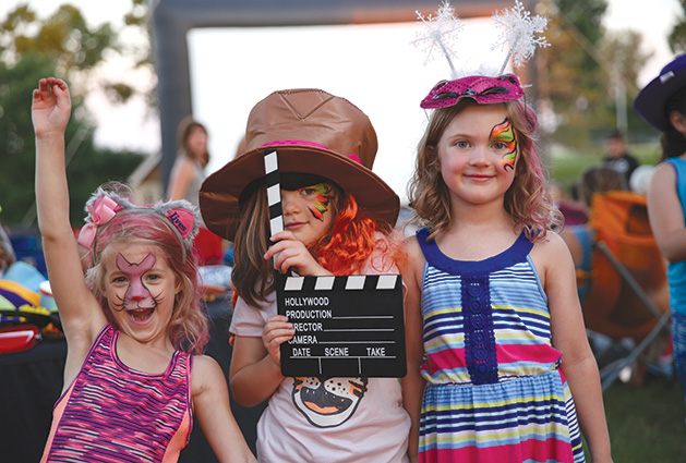 A group of young girls pose for a photo at Starlight Cinema, Woodbury's outdoor summer movie event.
