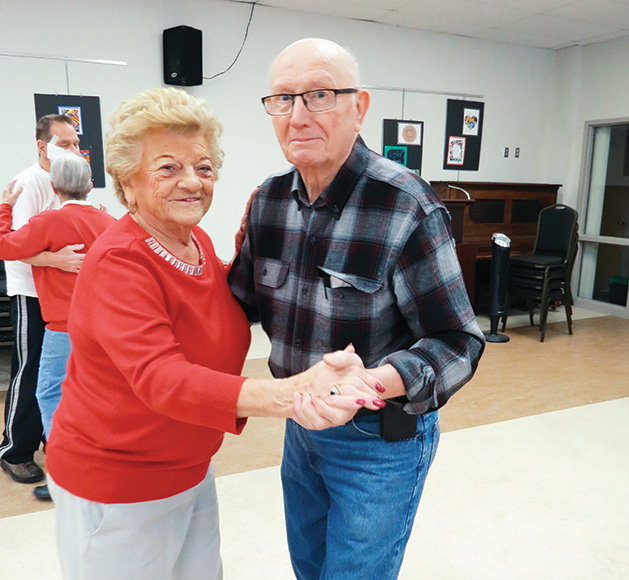 Two seniors dance at an event at DPC Community Center.