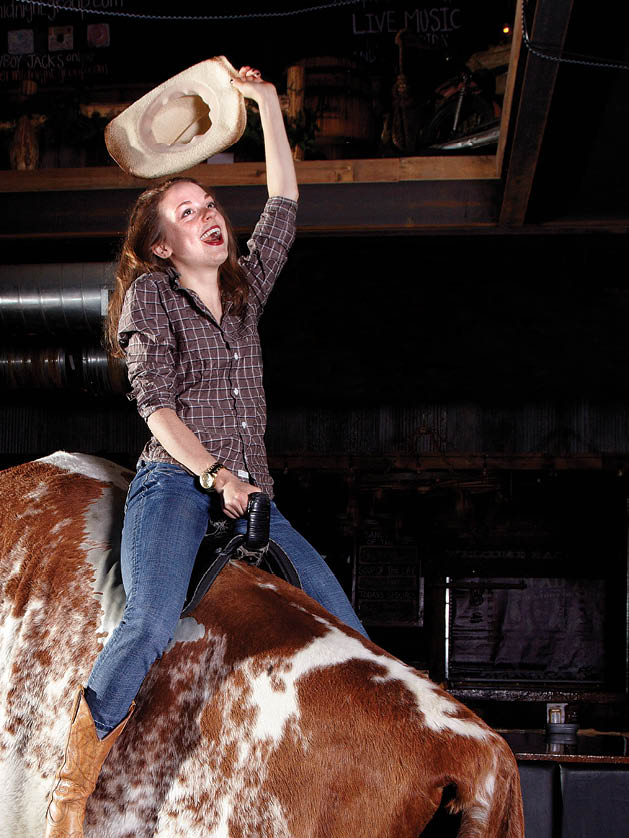 Leslie Olson rides the mechanical bull at Cowboy Jack's. Photo by Tate Carlson