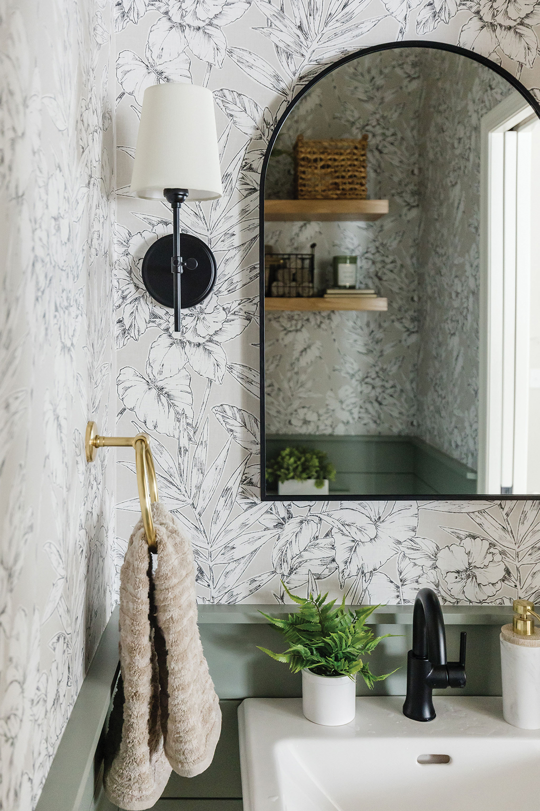 This bathroom reveals several important design trends that are on the rise, including floral wallpaper and nature-inspired tones.