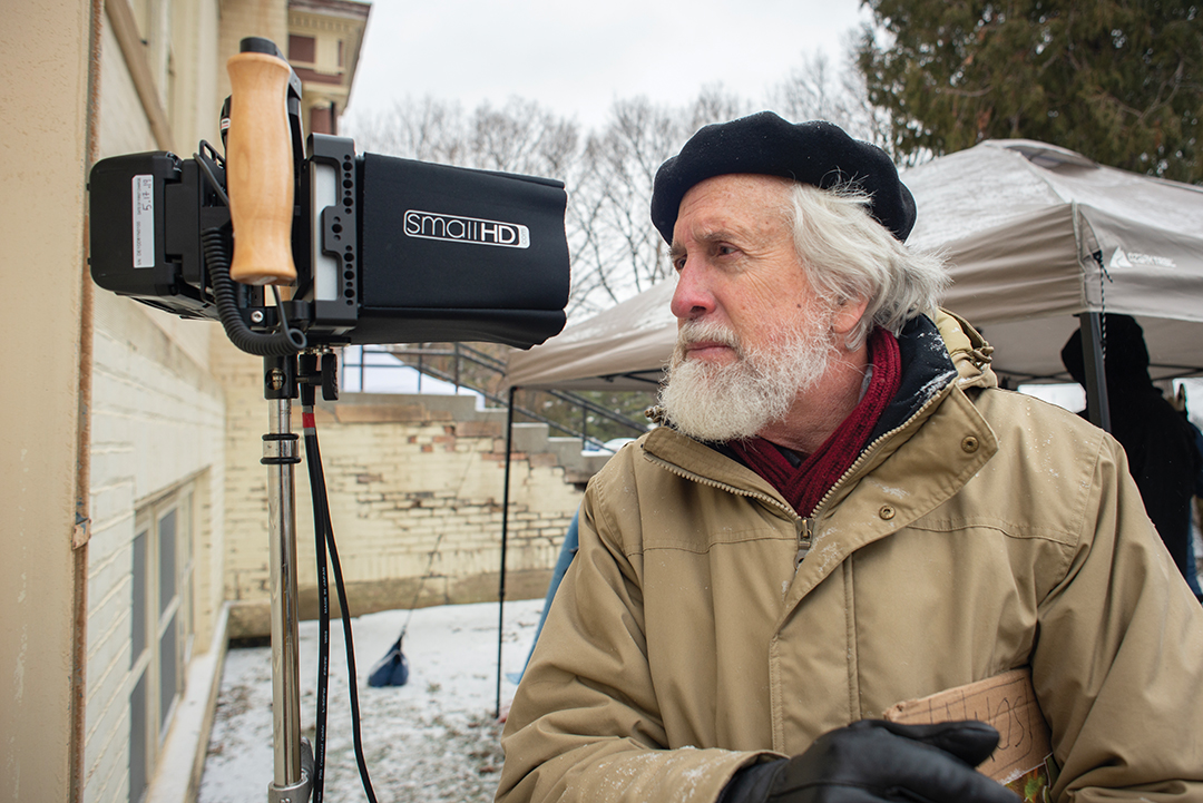 Cristóbal Krusen, serving as writer, director and actor, inspects video playback at the old Fergus Falls State Hospital.