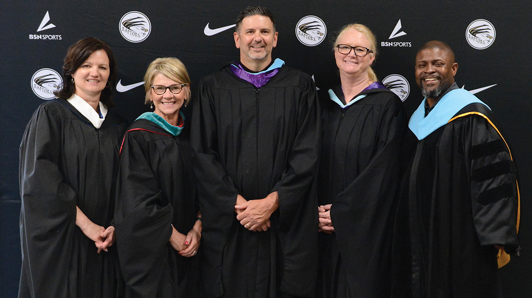 From left to right: Assistant superintendent Kristine Schaefer, Julie Nielsen, East Ridge High School (ERHS) principal James Smokrovich, assistant superintendents Kelly Jansen and Tyrone Brookins at the ERHS 2023 graduation ceremony.