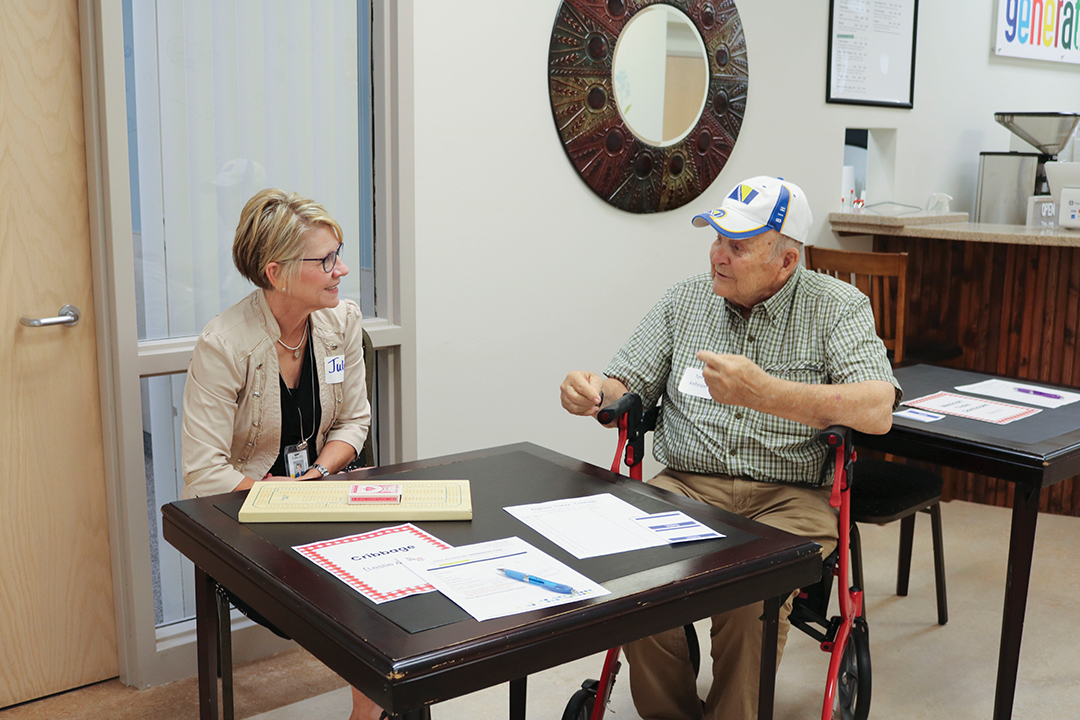 Julie Nielsen visits with a community member this fall during a senior activities program at the District Program Center.