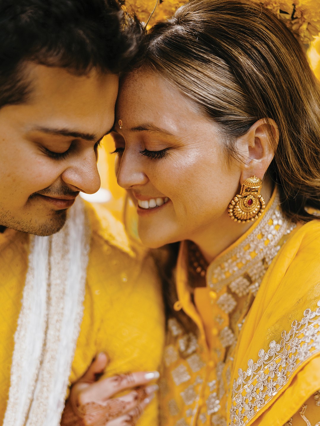 For the Haldi ceremony, Nan Sen wore a yellow Nidhi Tholia dress featuring gold accents, while Rishi Sen wore a yellow kurta from Manyavar Mohey. The bright yellow color of both outfits paid homage to the turmeric ceremony, a prewedding ritual that involves applying turmeric to the bride and groom. The couple opted to be showered with yellow rose petals instead.