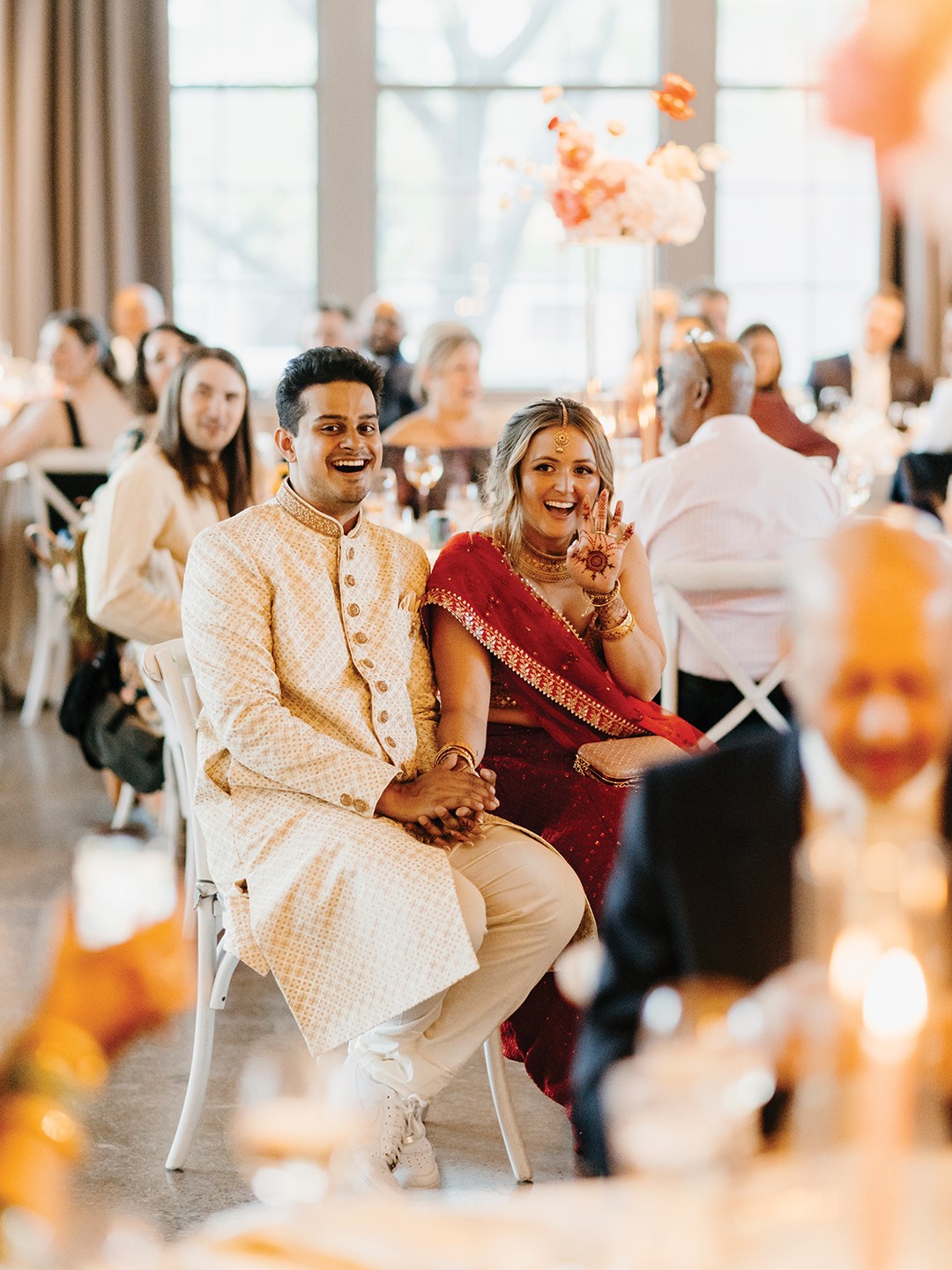 In the evening, Nan changed into a vibrant red lehenga designed by Anita Dongre, paired with a glamorous tikka headpiece, gold bangles and necklaces. With different hairstyles curated by Hair by Theresa for each event, including this braided look, the bride’s looks were as thoughtful as the day itself.