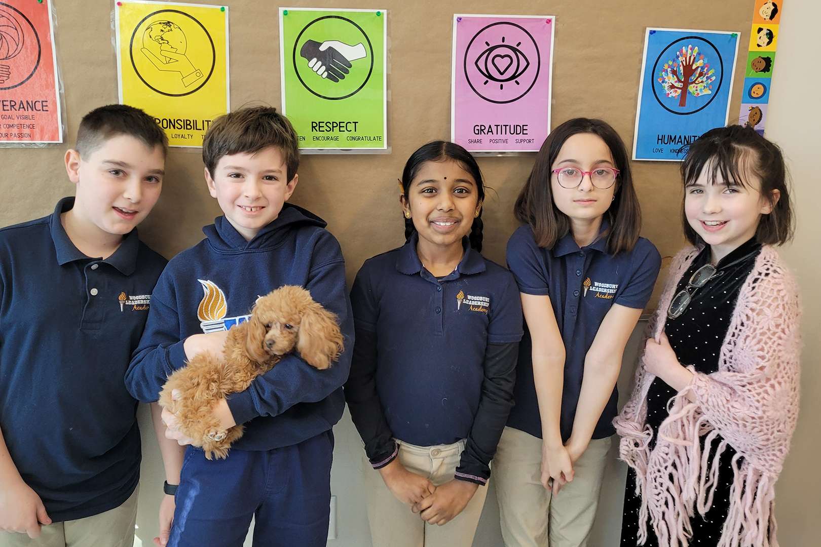 Woodbury Leadership Academy students with a rescue puppy from Coco’s Heart Dog Rescue.