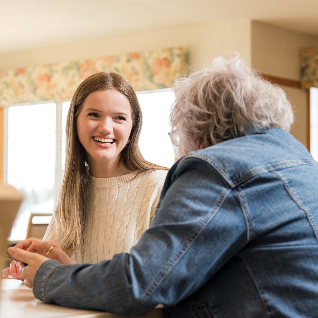 Mirella Janssen works with a resident at Stonecrest.
