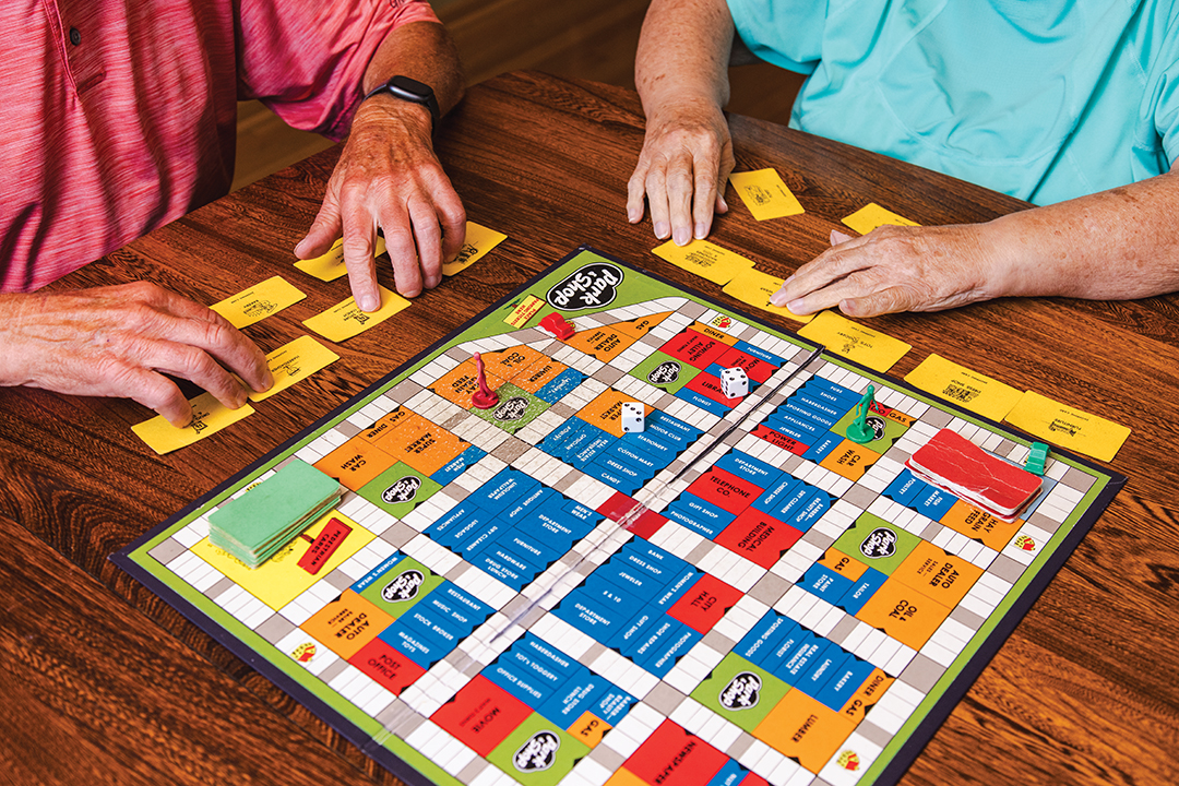 Besty and Dick Ellis enjoy playing board games together at their kitchen table. Betsy’s favorite is Park and Shop, a game from her childhood.