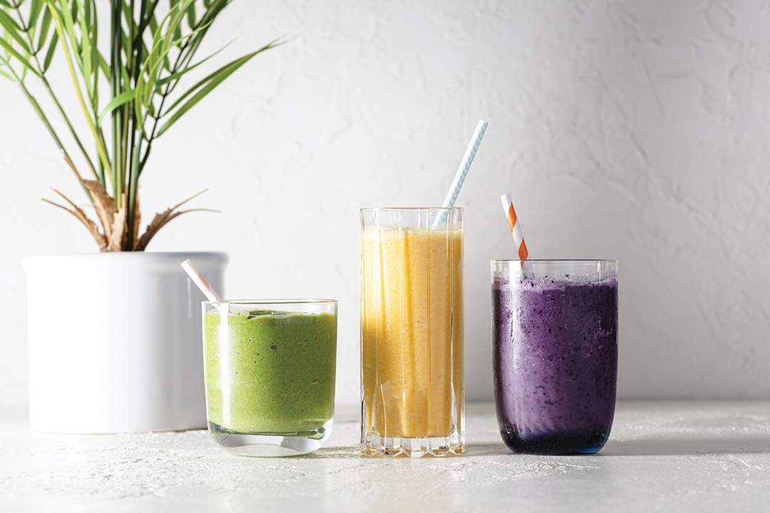 Three smoothies in different glasses.