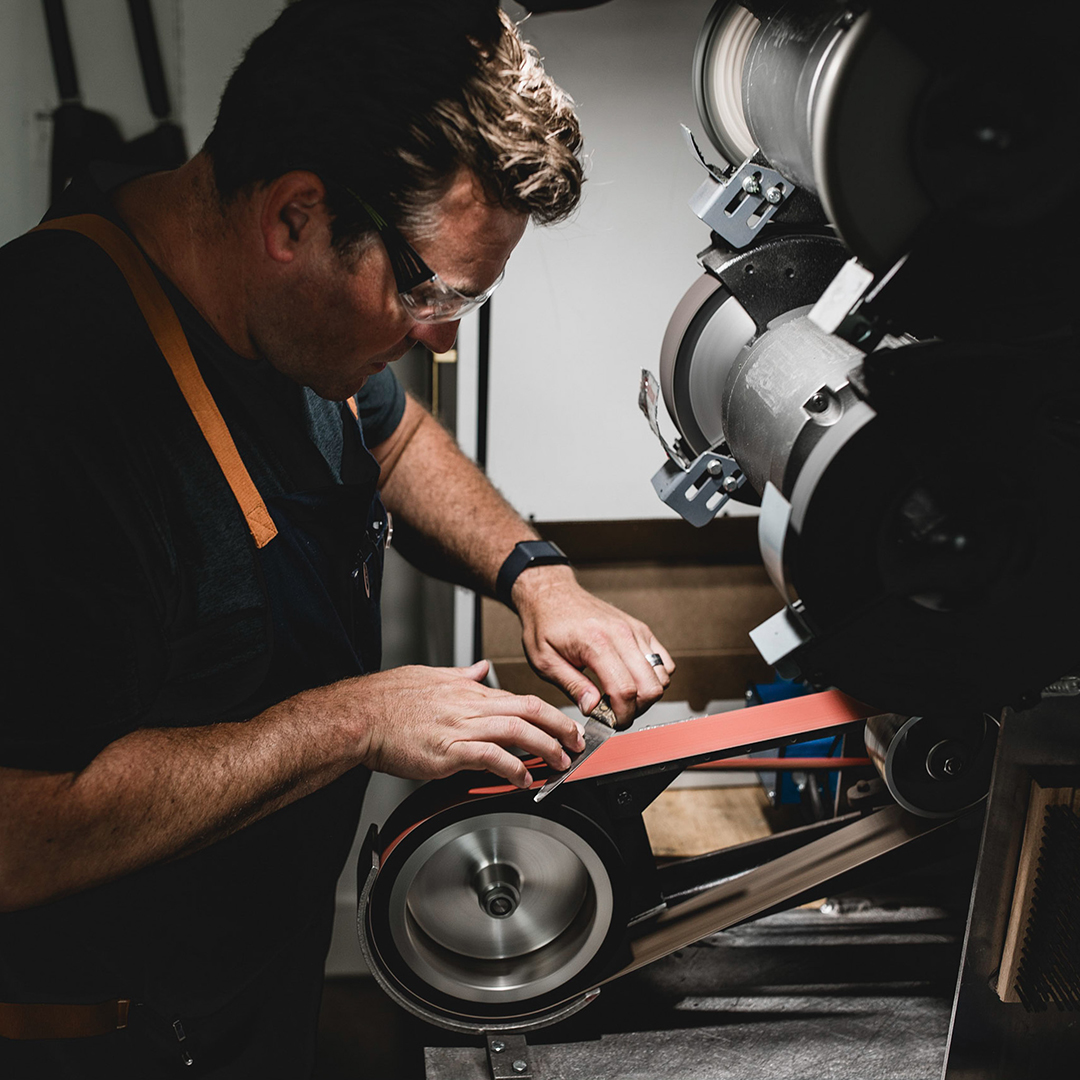 Joseph Rueter sharpening a kitchen knife.