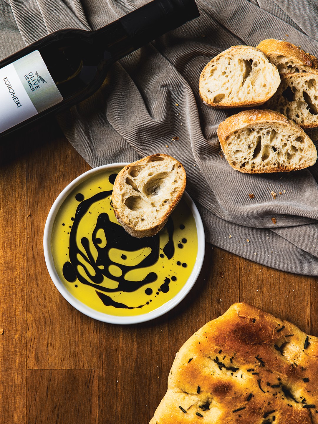 Oil and balsamic vinegar in a dish with slices of bread.