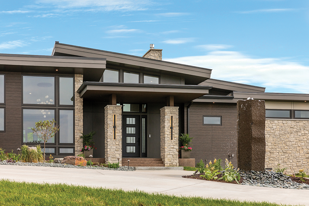 Inspired by the homes of California, this Woodbury abode sees water cascading in the front (on a 6,000-lb stone) and the rear (on a 32-foot rain screen) of the build.