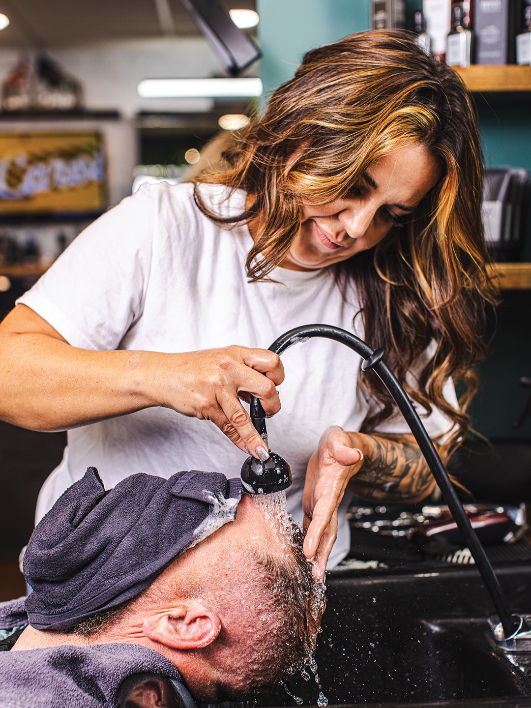 Washing client's hair.