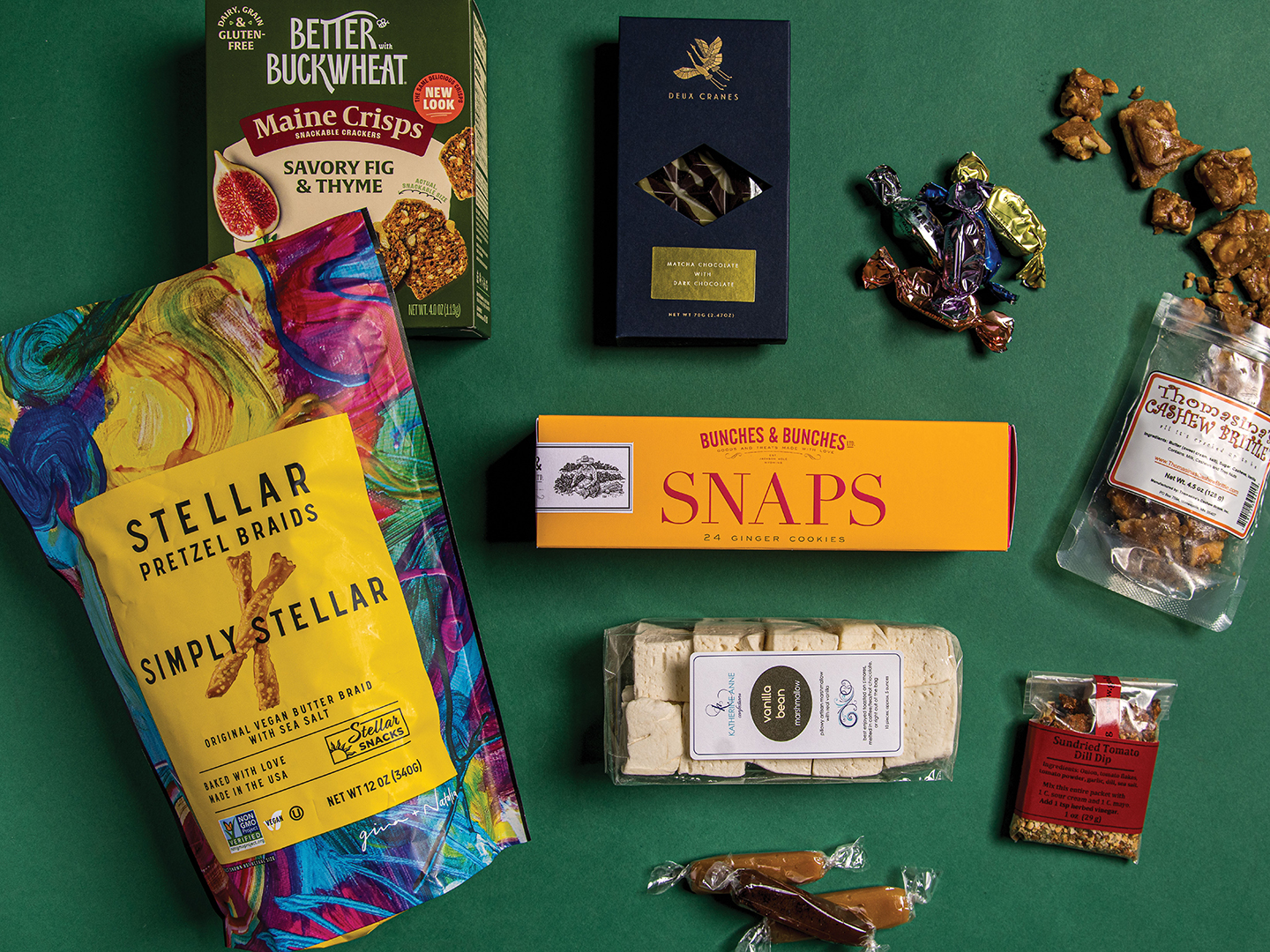 The Women-Owned Gift Box includes Bunches and Bunches cookies, a Deux Cranes Matcha Chocolate Bar, Golden Fig Dip, Katherine Anne Vanilla Bean Marshmallows, Maeve Chocolates, Maine Crisps crackers, Memas caramels, Stellar Pretzel Braids and Thomasina’s Cashew Brittle.