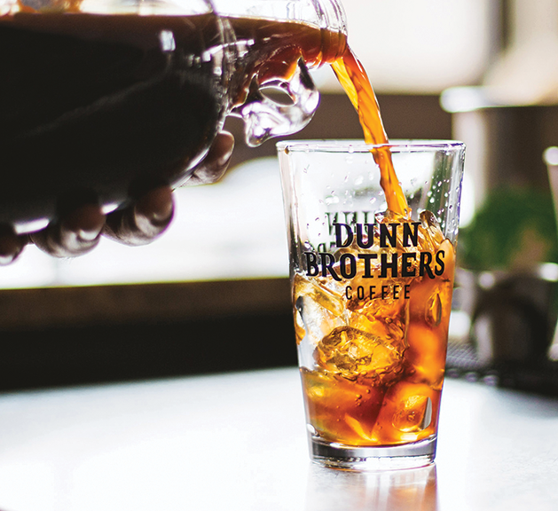 Dunn Brothers barista pouring cold brew coffee