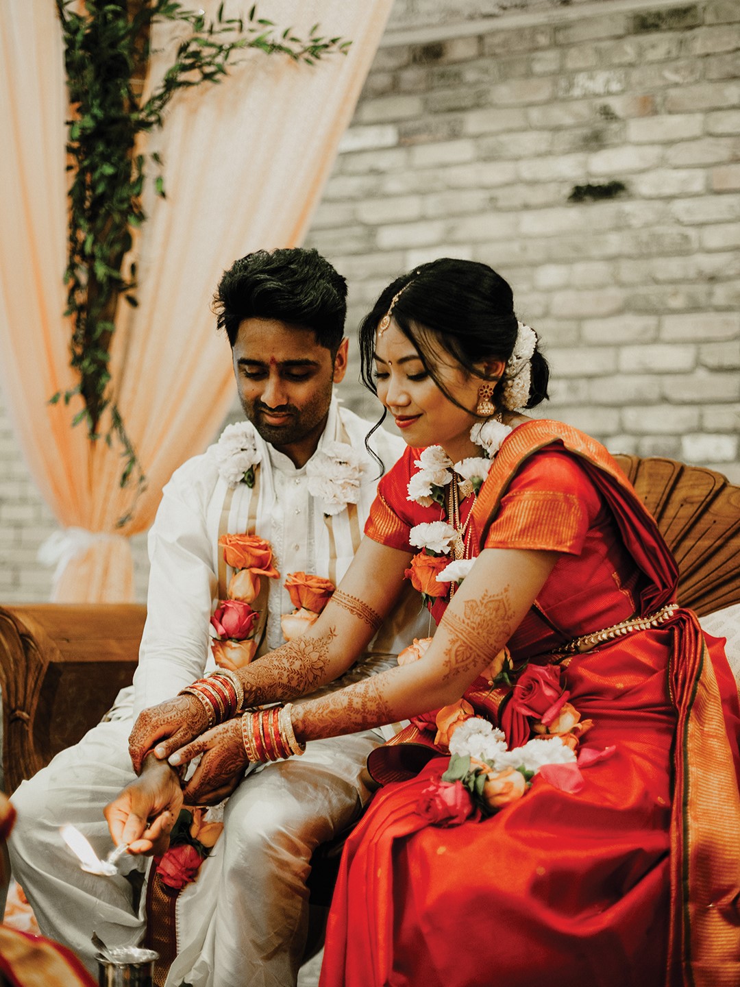 Quynh-Huong Van’s red-orange saree was chosen by her mother-in-law, and Vikram Nagarajan’s maternal aunts in India sent it to her as a gift.