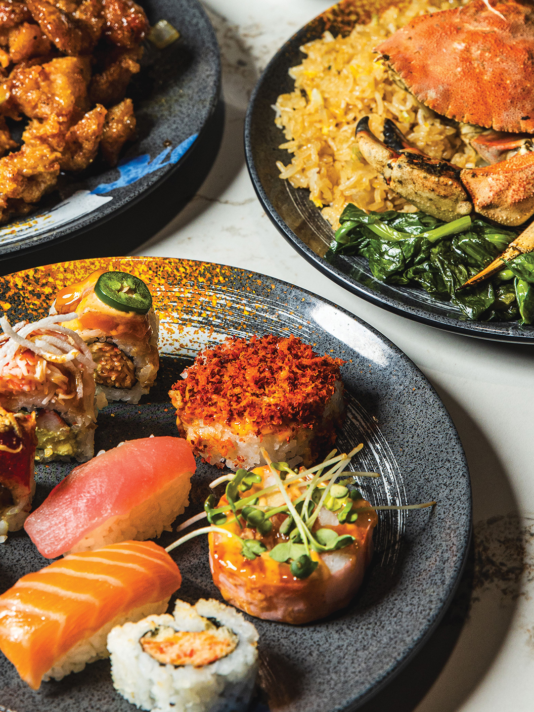Feast Buffet & Banquet guests will find a variety of choices, such as Beef and Broccoli (left plate), as well as new flavors like stone crab, fried rice and pea shoots (right plate). Sushi options are abundant, with unique picks such as the Volcano Roll.