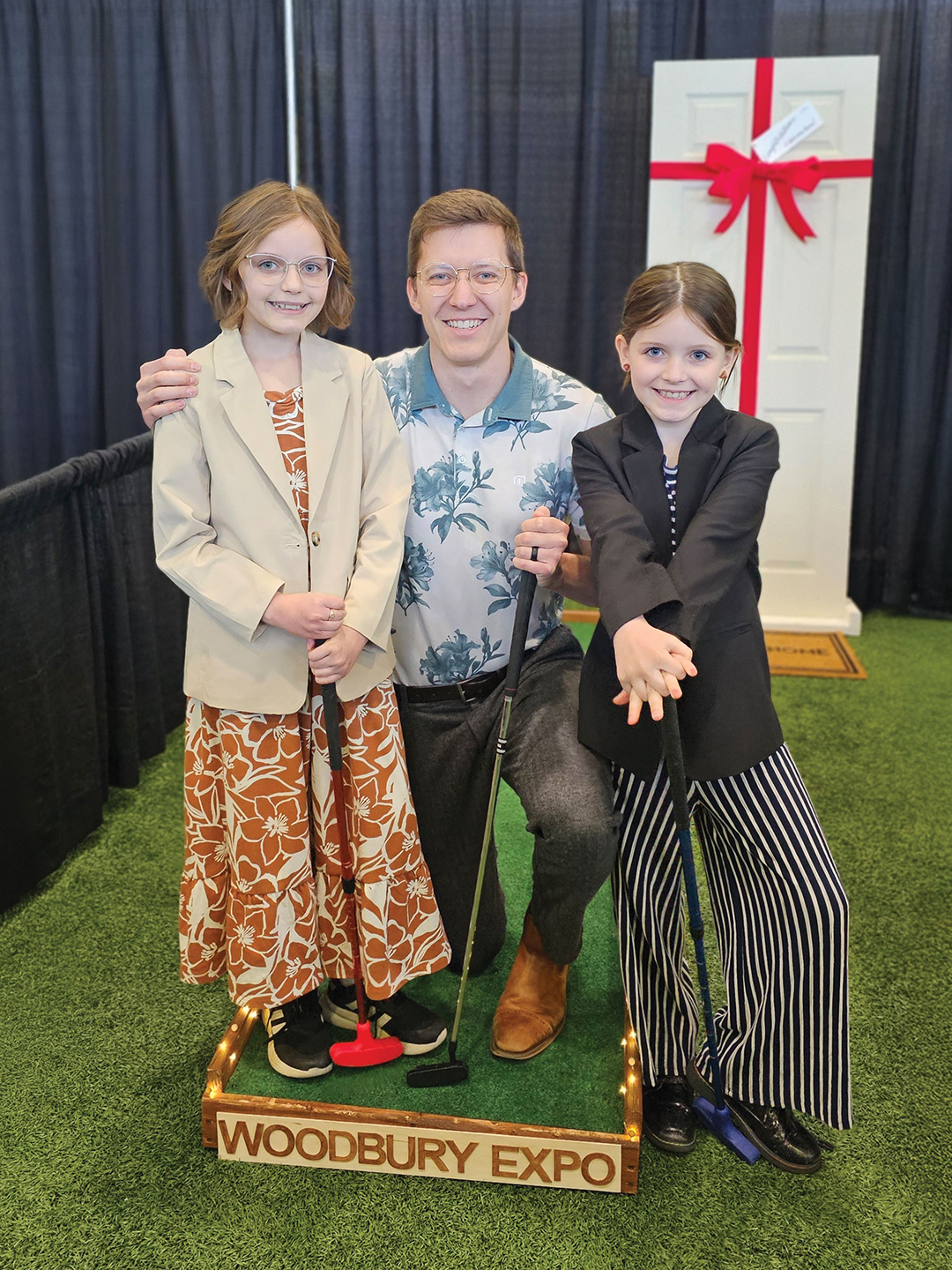 Tyler Martin (middle) alongside his daughters, Arabella, 10, and Ellora, 8. The sisters are the inspiration behind Backyard Birdies, an entertainment company offering rentable portable mini golf holes and yard games.
