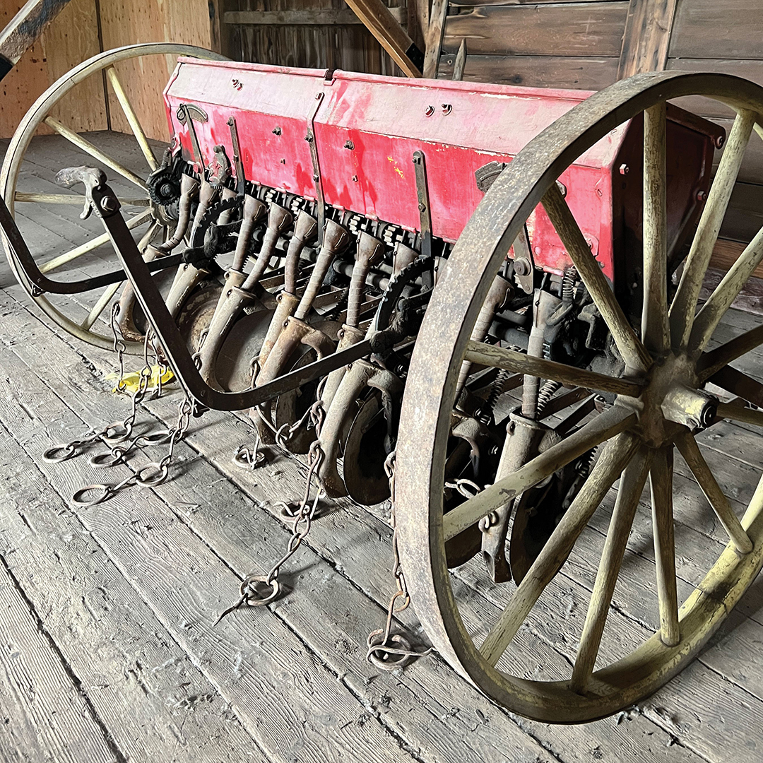 Museum consultant Rose Kubiatowicz researched this Van Brunt Seed Drill. Its elaborate mechanisms are used to plant seeds. Van Brunt was purchased by John Deere in 1911; after, drills were marketed as John Deere-Van Brunt Drills. However, this drill contains no John Deere markings.