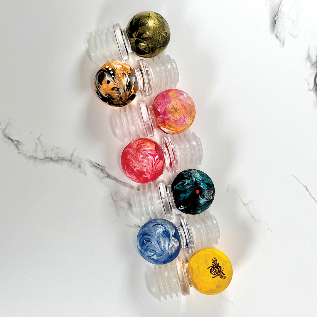 Madison Grainger’s hand-painted wine stoppers pair beautifully with her wine glasses.